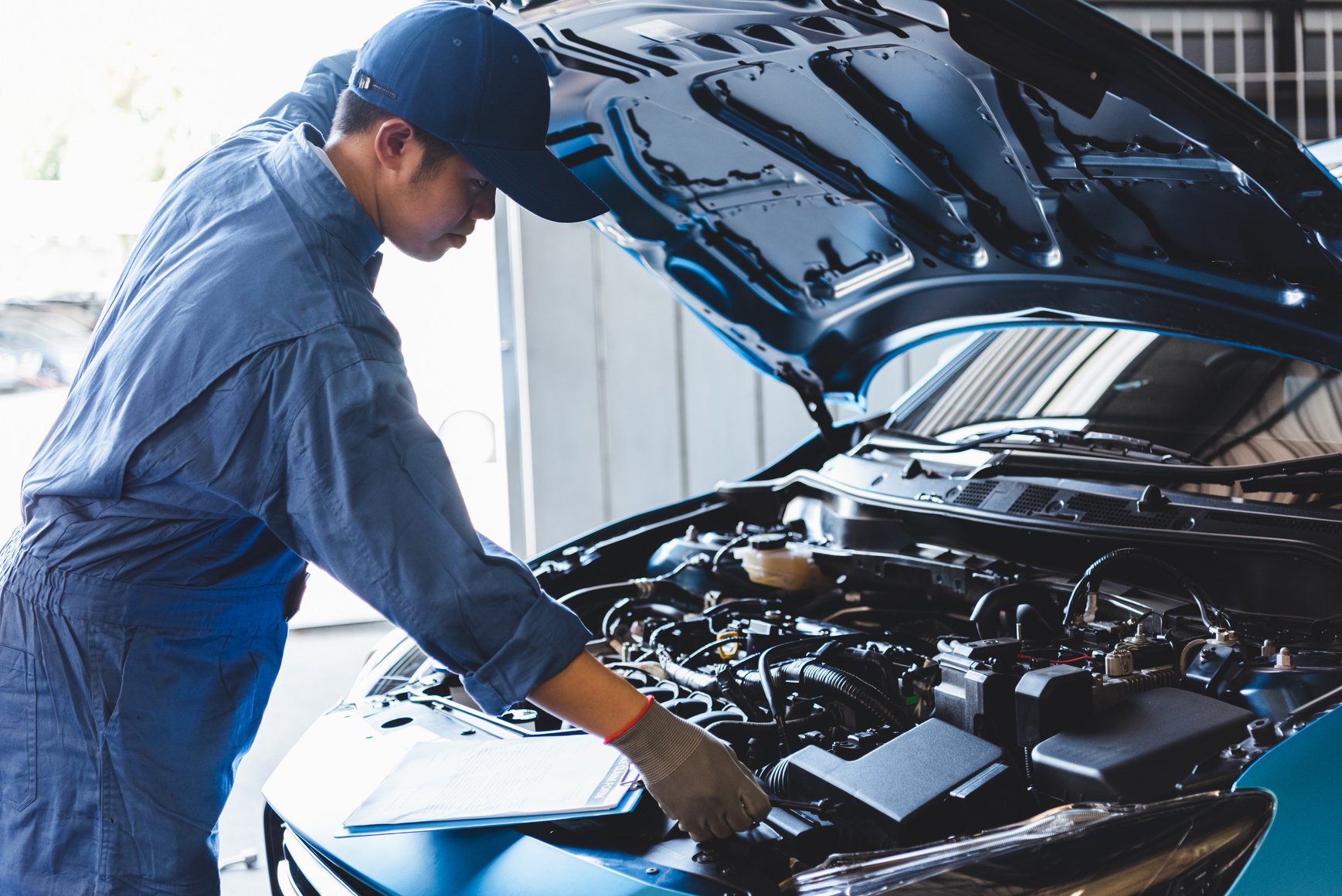 Car Mechanic Checking Car Engine 